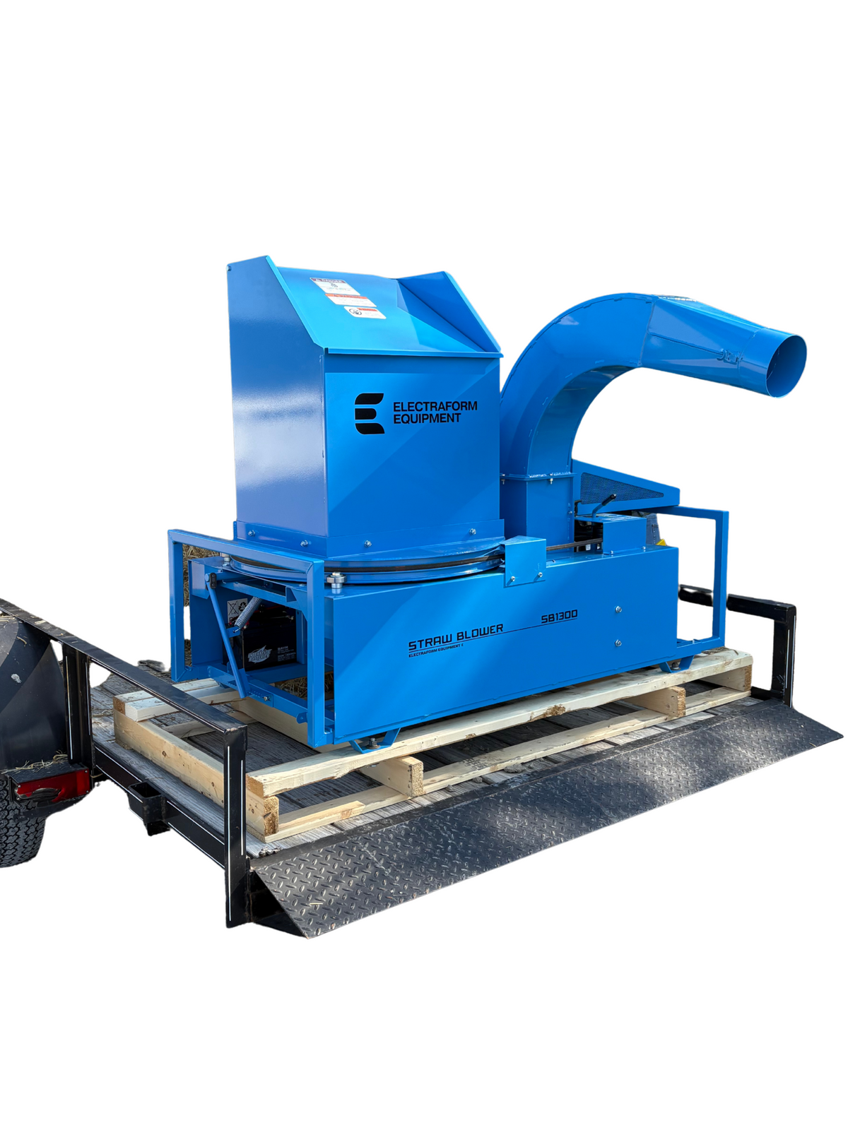 Blue straw blower on create on trailer